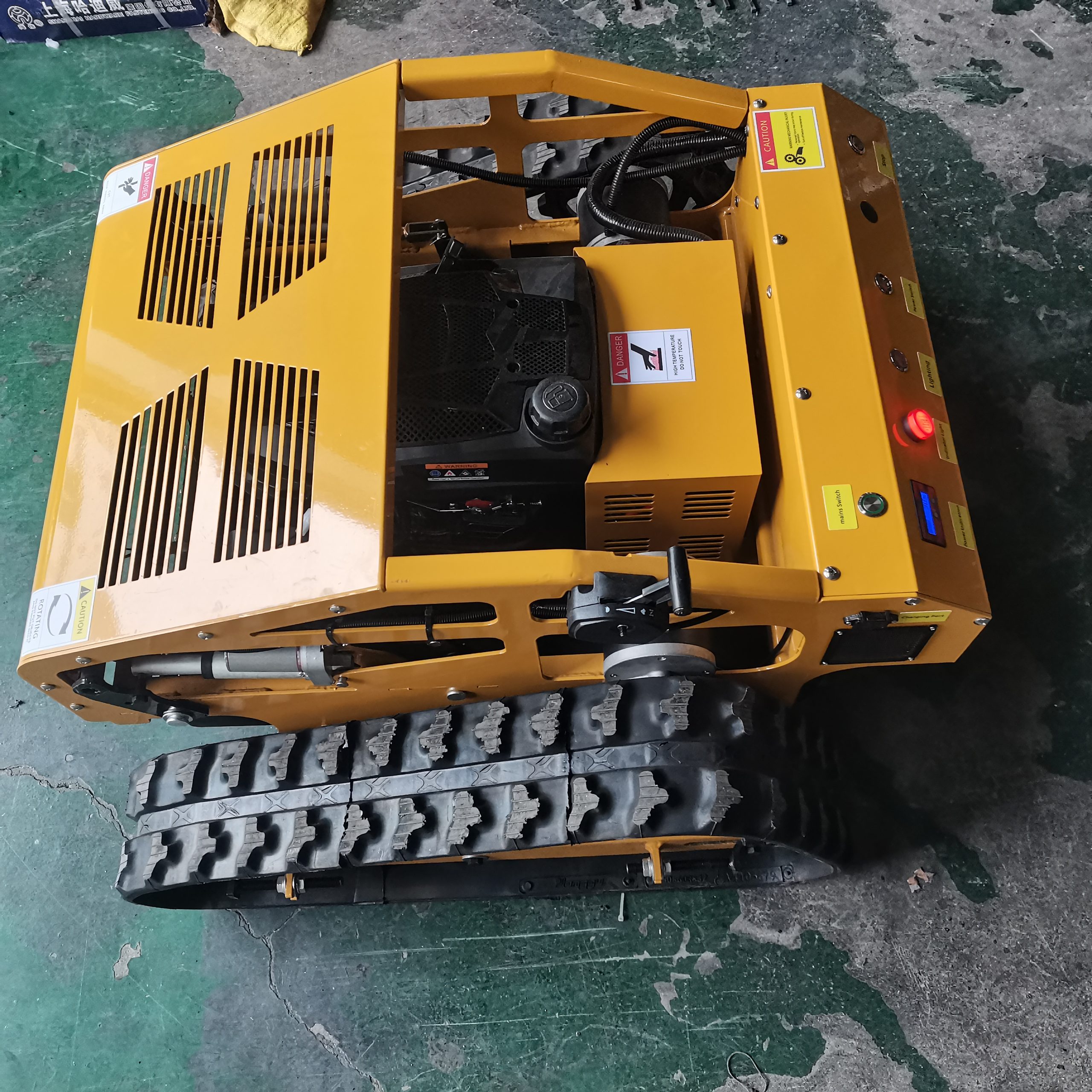 Yellow SH-550B remote control tracked lawn mower engine and control panel detail